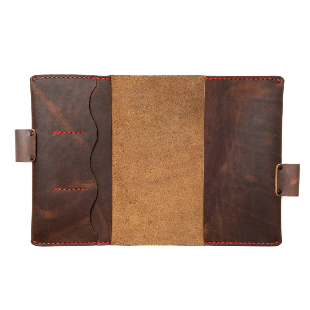 Brown leather notebook cover with red stitching on a white background