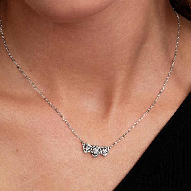 Necklace with heart-shaped pendant worn by a person