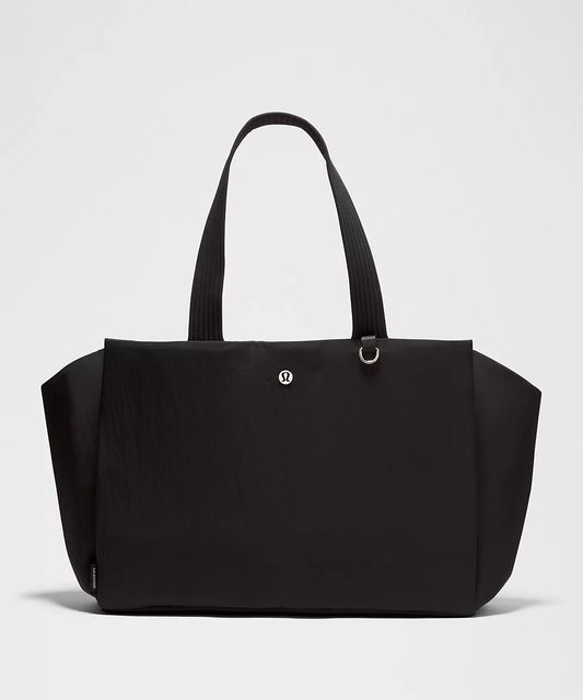Black tote bag on a light gray background