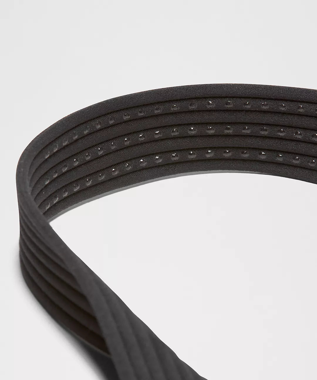 Close-up of a black bag handle on a light gray background