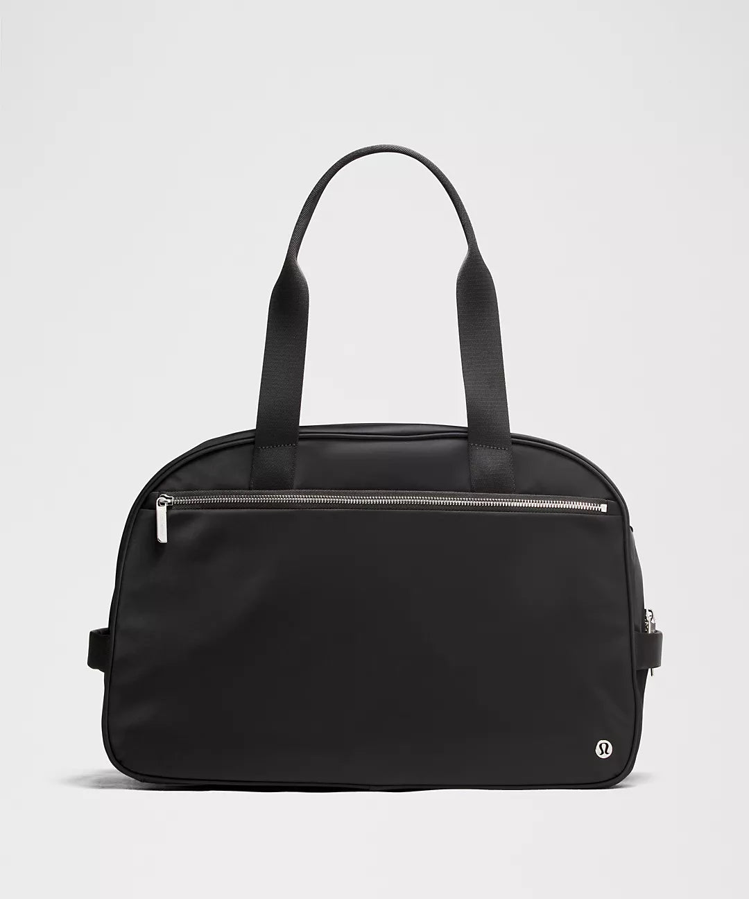 Black handbag with a zipper on a light gray background
