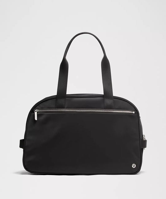 Black handbag with a zipper on a light gray background