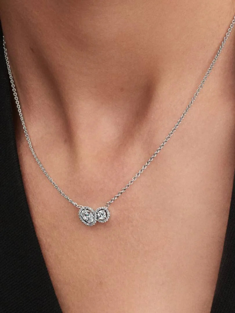 Silver necklace with a small pendant on a person's neck