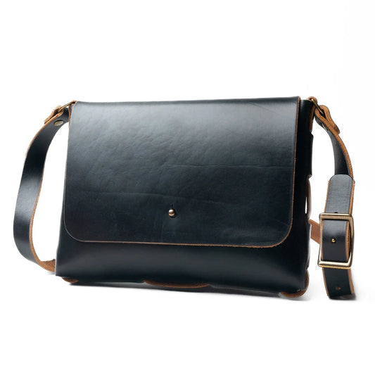 Black leather shoulder bag with brown accents on a white background